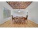 Cozy dining room showcasing hardwood floors, a unique ceiling, and a modern light fixture at 10125 Quarry Hill Pl, Parker, CO 80134