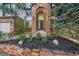 Charming front entrance showcasing brick archway, decorative lighting, and manicured landscaping at 10125 Quarry Hill Pl, Parker, CO 80134