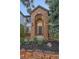 Beautifully landscaped front entrance highlighting brick archway, lighting, and lush greenery at 10125 Quarry Hill Pl, Parker, CO 80134