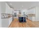 Updated kitchen with white cabinets, granite counters and a center island at 10125 Quarry Hill Pl, Parker, CO 80134