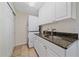 Laundry room with stacked washer/dryer, cabinets and a utility sink at 10125 Quarry Hill Pl, Parker, CO 80134