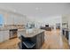 Open concept kitchen overlooks the living room with wall of windows at 10125 Quarry Hill Pl, Parker, CO 80134