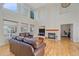 Bright living room featuring hardwood floors, a fireplace, and large windows at 10125 Quarry Hill Pl, Parker, CO 80134