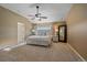 Spacious main bedroom with neutral walls, a ceiling fan, and a large bed with decorative pillows at 10125 Quarry Hill Pl, Parker, CO 80134
