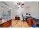 This office includes gorgeous hardwood floors, an elegant ceiling fan, and a door leading outside at 10125 Quarry Hill Pl, Parker, CO 80134