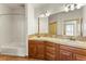 Bathroom featuring double sinks, neutral countertops, and a tub with shower at 10508 Christopher Dr, Conifer, CO 80433