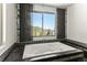 Bathroom soaking tub and picture window showcases panoramic view at 10508 Christopher Dr, Conifer, CO 80433