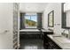 Bright bathroom with granite counters, dual sinks, and a soaking tub with mountain views at 10508 Christopher Dr, Conifer, CO 80433