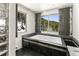 Bathroom featuring a luxurious soaking tub and picturesque views of snow-covered trees at 10508 Christopher Dr, Conifer, CO 80433