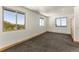 Bright bedroom with carpet and three windows providing natural light and a view at 10508 Christopher Dr, Conifer, CO 80433