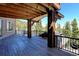 Spacious wooden deck with dark metal railings offers views of the mountainous landscape at 10508 Christopher Dr, Conifer, CO 80433