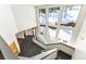 A modern entryway features a staircase and large windows with views of a winter wonderland at 10508 Christopher Dr, Conifer, CO 80433