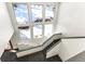 A bright entryway features a staircase and large windows with views of a winter wonderland at 10508 Christopher Dr, Conifer, CO 80433