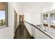 Upstairs hallway featuring wood floors and scenic views at 10508 Christopher Dr, Conifer, CO 80433