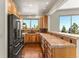 A kitchen showcasing custom cabinets, tile countertops, and modern, stainless steel appliances at 10508 Christopher Dr, Conifer, CO 80433