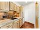 The laundry room area boasts wooden cabinets, a sink, and tile backsplash at 10508 Christopher Dr, Conifer, CO 80433