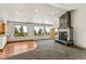 Living room boasts fireplace, large windows, and plush carpeting at 10508 Christopher Dr, Conifer, CO 80433
