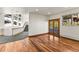 Spacious living room with hardwood floors, staircase access, and french doors leading to an outdoor deck at 10508 Christopher Dr, Conifer, CO 80433