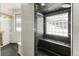 Contemporary shower showcasing glass block window and built-in seat at 10508 Christopher Dr, Conifer, CO 80433