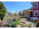 Cozy backyard with a small patio and garden beds, ideal for outdoor living at 8335 E 22Nd Ave, Denver, CO 80238