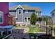 A spacious backyard with stone patio, garden beds and white picket fence, great for entertaining at 8335 E 22Nd Ave, Denver, CO 80238