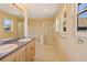 This bathroom features a double vanity, a walk-in shower, and a soaking tub at 8335 E 22Nd Ave, Denver, CO 80238