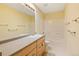 This bathroom features a shower/tub combo and a long vanity with lots of drawer space at 8335 E 22Nd Ave, Denver, CO 80238