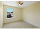 This bedroom features neutral paint, carpet, and a sunny window at 8335 E 22Nd Ave, Denver, CO 80238
