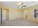 Spacious bedroom with carpet, ceiling fan, with entry to bathroom and walk-in closet at 8335 E 22Nd Ave, Denver, CO 80238