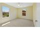 This bedroom features carpet, neutral paint, and two sunny windows at 8335 E 22Nd Ave, Denver, CO 80238