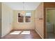 Bright dining area featuring wood floors, large windows, designer lighting and adjacent laundry room at 8335 E 22Nd Ave, Denver, CO 80238