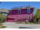 Two-story home featuring solar panels, a two-car garage, and garden area at 8335 E 22Nd Ave, Denver, CO 80238
