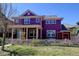 Two-story purple home with a welcoming front porch and white picket fence under a clear blue sky at 8335 E 22Nd Ave, Denver, CO 80238