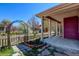 Charming front porch with columns, garden and metal archway, offering curb appeal at 8335 E 22Nd Ave, Denver, CO 80238