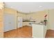 Kitchen featuring a full suite of appliances, laminate wood floors, and adjacent dining area at 8335 E 22Nd Ave, Denver, CO 80238