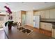 Spacious kitchen with stainless sink, light wood cabinets, and eat-in area at 8335 E 22Nd Ave, Denver, CO 80238