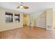 Bright living room boasts hardwood floors, large windows, and a stairway with grasscloth accent wall at 8335 E 22Nd Ave, Denver, CO 80238