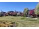 Inviting neighborhood with manicured lawns and colorful trees in a residential area at 8335 E 22Nd Ave, Denver, CO 80238
