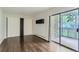 Bright bedroom with hardwood floors, a closet, and a sliding glass door leading to a balcony at 13691 E Marina Dr # 107, Aurora, CO 80014