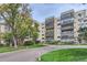 Multi-story condominium building with mature landscaping and trees at 13691 E Marina Dr # 107, Aurora, CO 80014