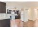 Modern kitchen with dark wood cabinets, white appliances, and tile backsplash offering a functional and stylish cooking space at 13691 E Marina Dr # 107, Aurora, CO 80014
