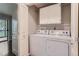 Convenient laundry room with a full-size washer and dryer and storage cabinets at 13691 E Marina Dr # 107, Aurora, CO 80014