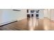 Bright living area featuring sleek, modern dark wood-look floors, with the kitchen conveniently located in the background at 13691 E Marina Dr # 107, Aurora, CO 80014