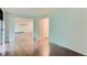 Open floorplan with hardwood floors and an open doorway to another room, bright natural light at 13691 E Marina Dr # 107, Aurora, CO 80014