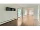 Living room with hardwood floors, access to a screened-in patio, and an open layout at 13691 E Marina Dr # 107, Aurora, CO 80014