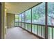 Covered patio enclosed with glass, offering a view of the surrounding neighborhood and trees at 13691 E Marina Dr # 107, Aurora, CO 80014