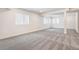 The open basement space offers great potential, featuring neutral carpet, natural light, and ample room for customization at 2177 Garden Ave, Brighton, CO 80601