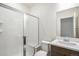 Well lit bathroom featuring a glass enclosed shower and modern vanity at 2177 Garden Ave, Brighton, CO 80601