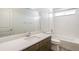 A bathroom featuring a quartz countertop, modern sink, and a bathtub with tiled walls, blending style and functionality at 2177 Garden Ave, Brighton, CO 80601