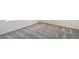 A bedroom features neutral carpet, creating a clean and versatile foundation for personalization and comfort at 2177 Garden Ave, Brighton, CO 80601